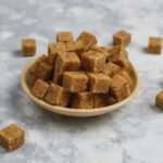 Brown sugar cubes on concrete background,top view